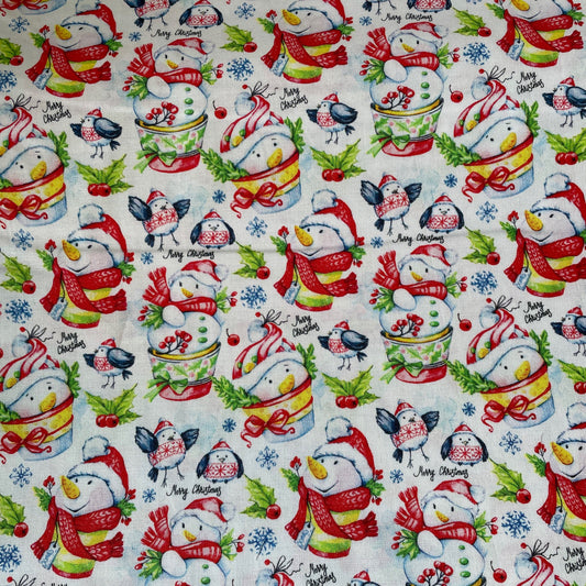 Christmas-themed fabric with colorful snowmen and winter elements on a white background