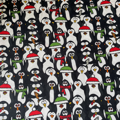 Pattern of cartoon penguins wearing winter hats and scarves on a black background