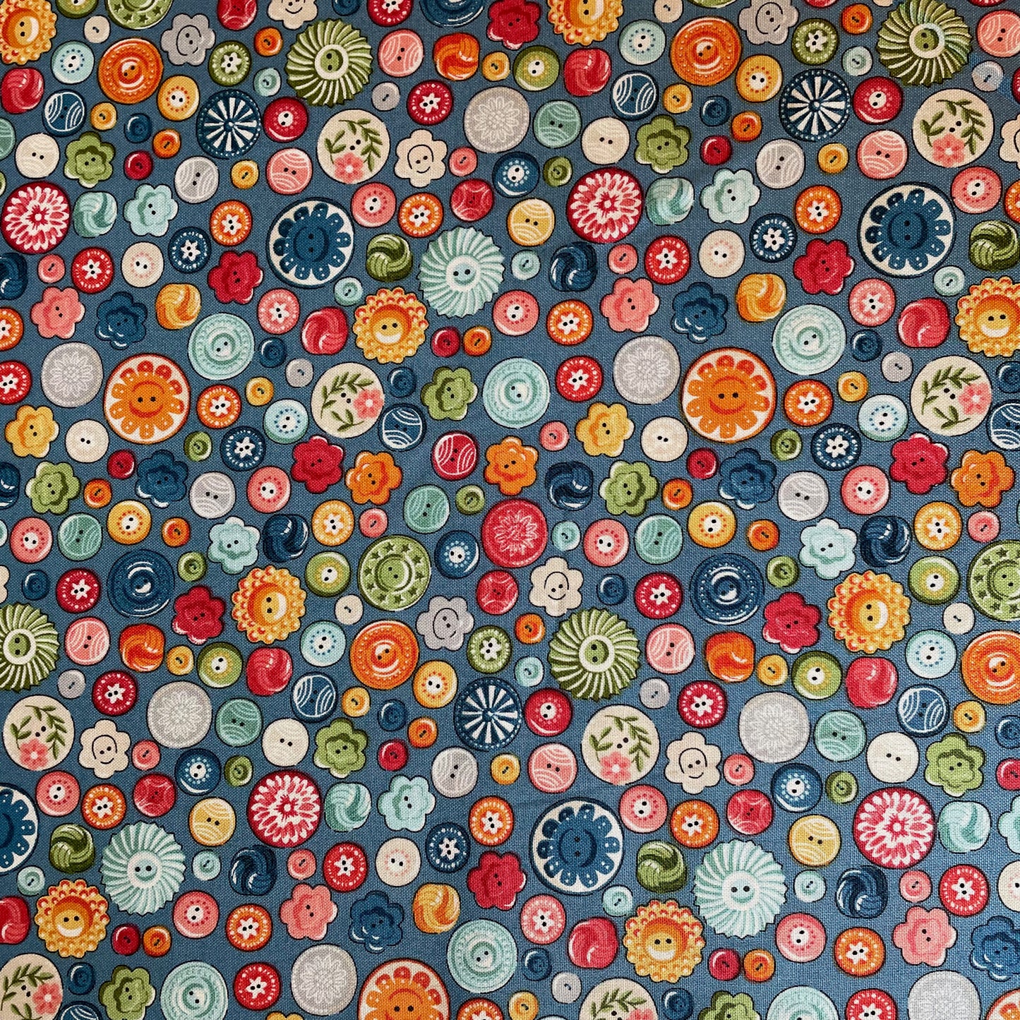 Colourful pattern of various button shapes and sizes on a blue background