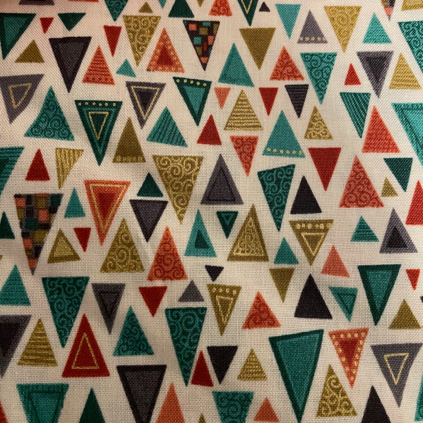 Patterned fabric with colorful triangles on a beige background