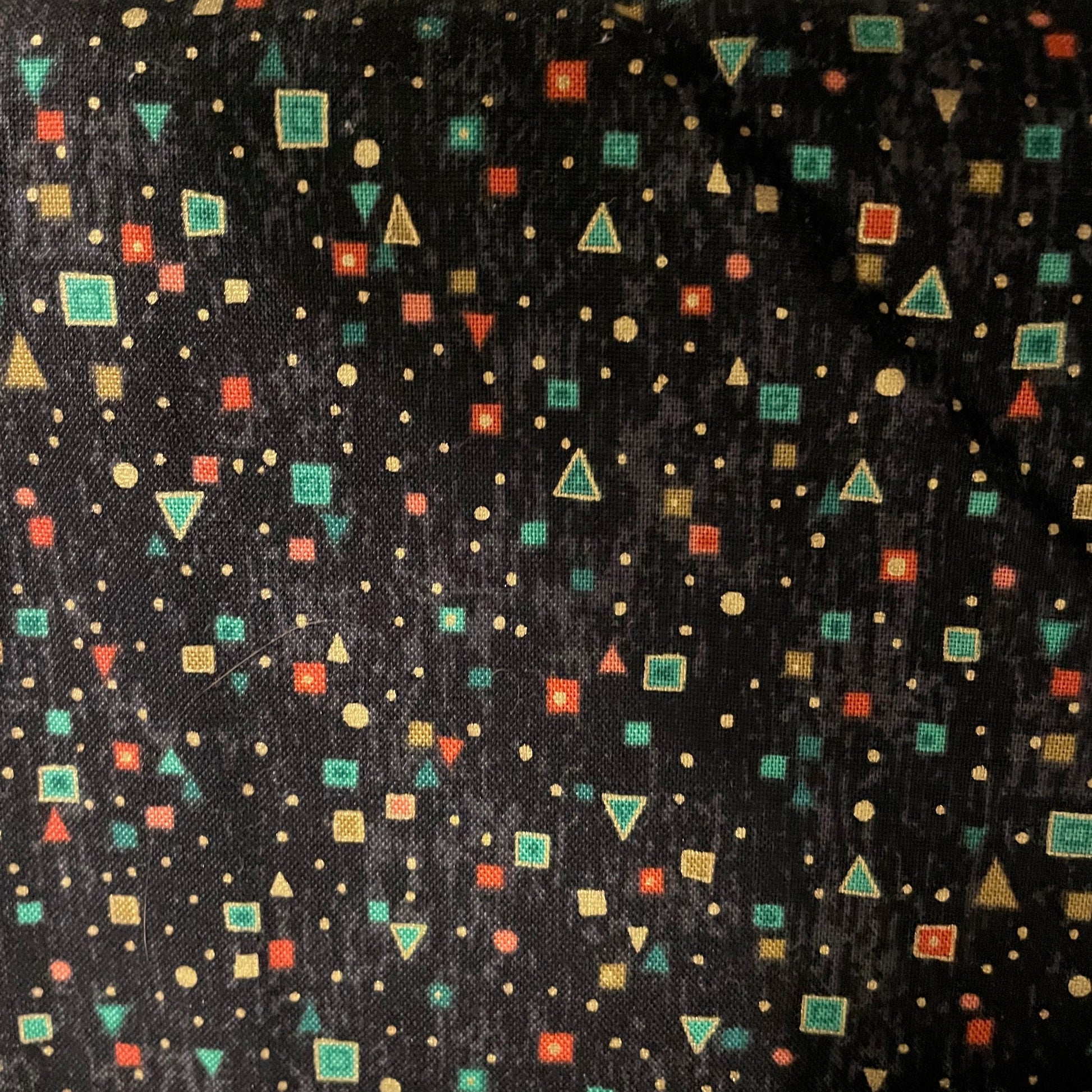 Patterned fabric with geometric shapes on a black background
