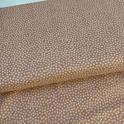 Brown fabric with a small white star pattern